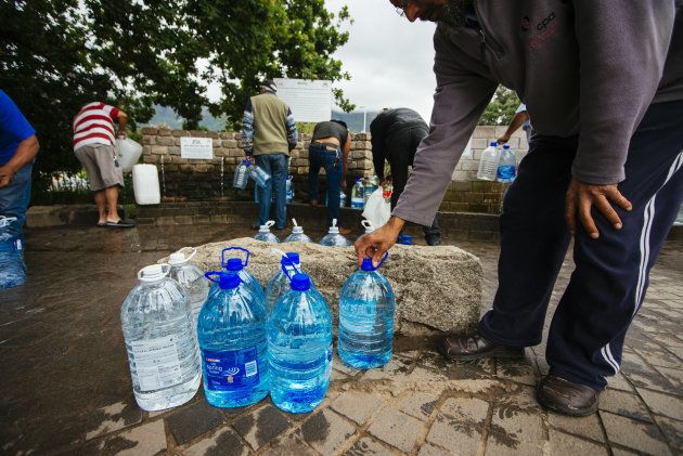 Residents fill water bottles and containers at the Newlands natural water spring in Cape Town, South Africa on Monday, Nov. 13, 2017.