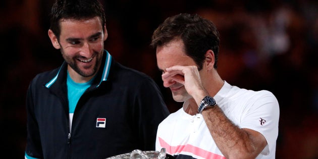 Tennis - Australian Open - Men's singles final - Rod Laver Arena, Melbourne, Australia, January 28, 2018. Switzerland's Roger Federer celebrates with the trophy after winning the final against Croatia's Marin Cilic.