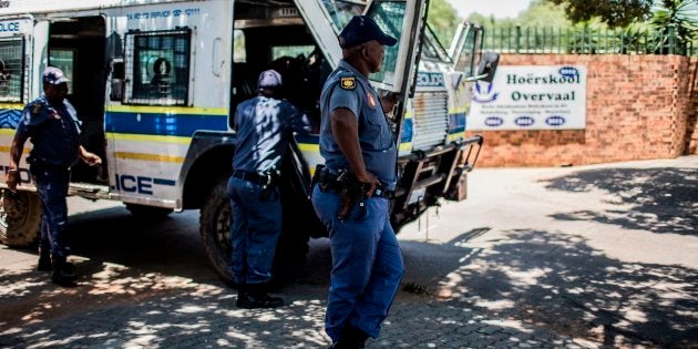 South African Police officers outside Hoërskool Overvaal during a protest.