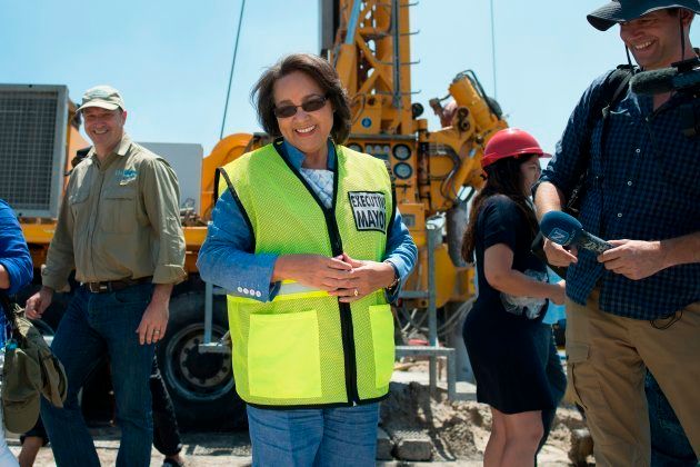 Cape Town City Mayor Patricia de Lille (C) talks to media at a site where the city council has ordered drilling into the aquifer to tap water, in Mitchells Plain, about 25km from the city centre on January 11, 2018 in Cape Town.