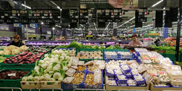 Customers shop vegetables displayed in the fresh foods section at Carrefour's Bercy hypermarket in Charenton, a Paris suburb, February 8, 2013.