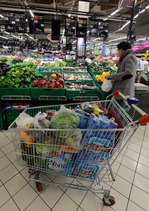 A customer shops vegetables displayed in the fresh foods section at Carrefour's Bercy hypermarket in Charenton, a Paris suburb, February 8, 2013.