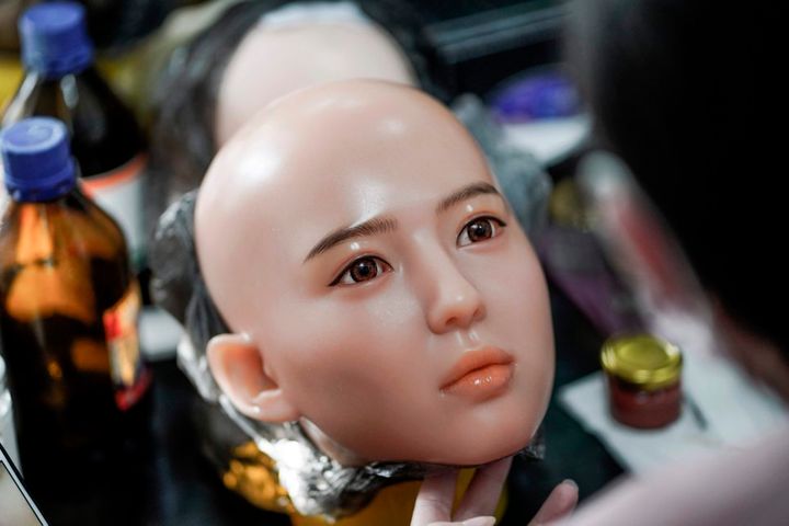 This photo taken on February 1, 2018 shows a worker painting the face of a silicone doll at a factory of EXDOLL, a firm based in the northeastern Chinese port city of Dalian. With China facing a massive gender gap and a greying population, a company wants to hook up lonely men and retirees with a new kind of companion: "Smart" sex dolls that can talk, play music and turn on dishwashers. / AFP PHOTO / FRED DUFOUR / TO GO WITH China-sex-lifestyle, FOCUS by Joanna CHIUFRED DUFOUR/AFP/Getty Images