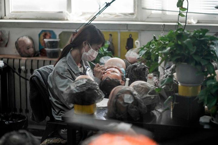 This photo taken on February 1, 2018 shows a worker painting the face of a silicone doll at a factory of EXDOLL, a firm based in the northeastern Chinese port city of Dalian. With China facing a massive gender gap and a greying population, a company wants to hook up lonely men and retirees with a new kind of companion: "Smart" sex dolls that can talk, play music and turn on dishwashers. / AFP PHOTO / FRED DUFOUR / TO GO WITH China-sex-lifestyle, FOCUS by Joanna CHIUFRED DUFOUR/AFP/Getty Images