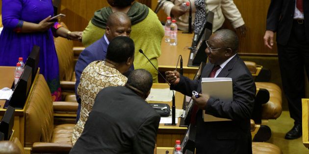 South Africa's African National Congress (ANC) party member and South African Deputy President Cyril Ramaphosa (C) reacts following the results of a vote of no-confidence against President Jacob Zuma on August 8, 2017 at the National Assembly in Cape Town.South Africa President Jacob Zuma on August 8 survived a parliamentary vote of no confidence, as ruling ANC party lawmakers stuck by their leader despite growing divisions and fierce criticism of his rule. Baleka Mbete, the Speaker of parliament, announced that the motion had been defeated, with 177 votes supporting and 198 votes against it. / AFP PHOTO / POOL / Mark Wessels (Photo credit should read MARK WESSELS/AFP/Getty Images)
