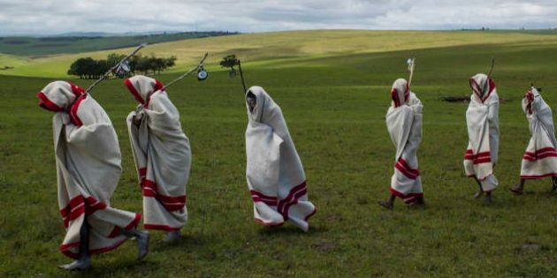 Xhosa Initiates pass by close to the funeral of Nelson Mandela, Qunu, South Africa, 14 December 2014.