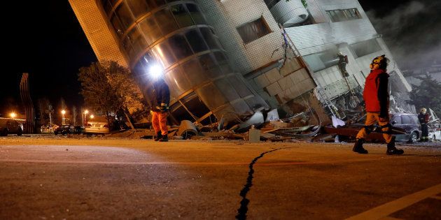 Rescue personnel search a collapses building after an earthquake hit Hualien, Taiwan February 7, 2018.