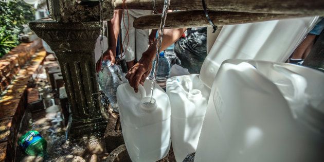 Cape Town residents queue to refill water bottles at Newlands Spring on January 31, 2018, in Cape Town.