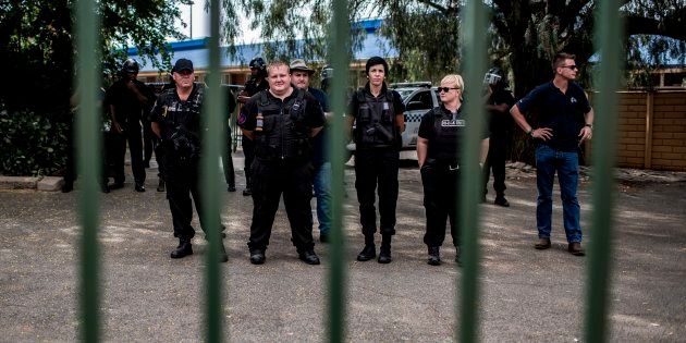 Members of the Civil society group Afriforum's private security stand guard inside the school, as members (not pictured) of the South African Democratic Teachers Union (SADTU) demonstrate outside Overvaal school against the school's language and admission policies, on January 22, 2018 in Vereeniging, south of Johannesburg.