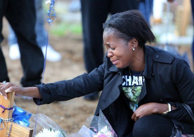 Peguy Kato mourning her son at his graveside on what would've been his 18th birthday.