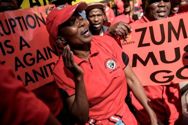 Confederation Of South African Trade Unions (COSATU) members cheer and dance as they march through the streets protesting against corruption on September 27, 2017 in Johannesburg. Thousands of angry South African trade unionists took to the streets across the nation on September 27, demanding the resignation of South African president Jacob Zuma and the institution of Judicial Enquiry Commission over alleged top-level corruption. / AFP PHOTO / GIANLUIGI GUERCIA (Photo credit should read GIANLUIGI GUERCIA/AFP/Getty Images)