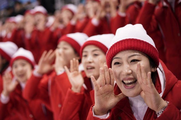 North Korean supporters cheer during the preliminary round of the women's hockey game between Switzerland and the combined Koreas at the 2018 Winter Olympics in Gangneung, South Korea on Feb. 10, 2018.