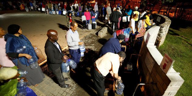 People queue to collect water from a spring in the Newlands suburb as fears over the city's water crisis grow in Cape Town.