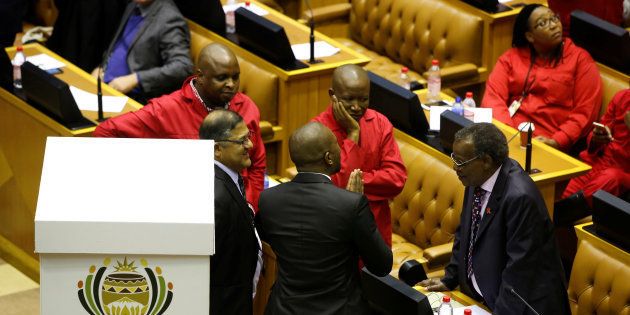 Opposition party leaders confer shortly before voting during the motion of no confidence in President Jacob Zuma last year.