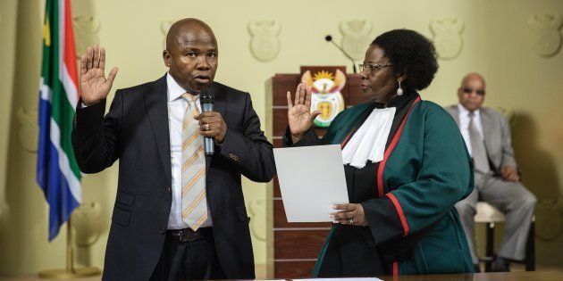 David Douglas Des van Rooyen (L) raises his hand as he is sworn-in by Justice minister Sisi Khampepe as the new South African Finance Minister on December 10, 2015 at Union Builidngs in Pretoria, South Africa.