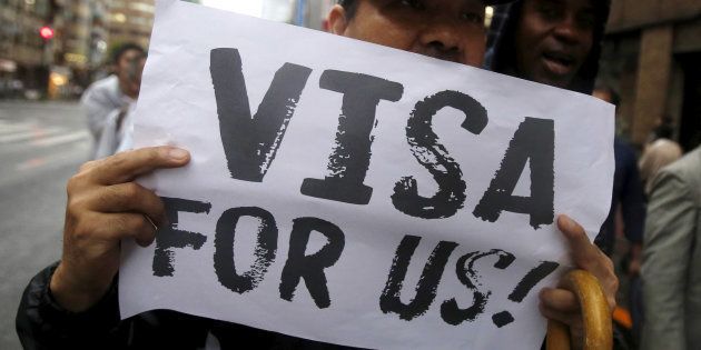 A protester holding a placard shouts slogans at a rally to call for visa grants for asylum seekers in Japan, in central Tokyo, September 9, 2015.