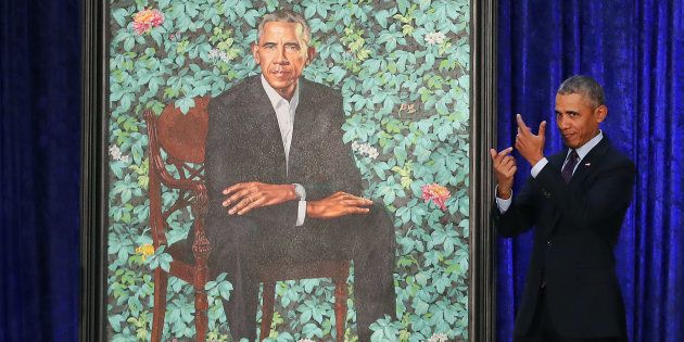 Former U.S. president Barack Obama stands next to his newly unveiled portrait.