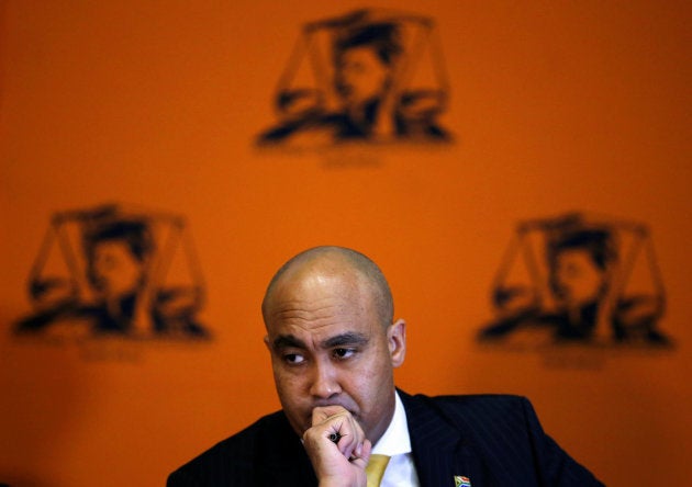 Head of the National Prosecuting Authority, Shaun Abrahams gestures as he announces the dropping of fraud charges on Monday against Finance Minister Pravin Gordhan, the latest twist in a police investigation that has rattled financial markets in the continent's most industrialised economy, during a media briefing, in Pretoria, South Africa, October 31,2016. REUTERS/Siphiwe Sibeko