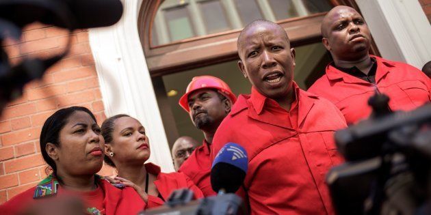 EFF leader Julius Malema (2R) talks to the press after staging a walk out during the election by the Members of Parliament of the new South African President on February 15, 2018 in Cape Town.
