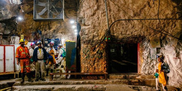 Miners stand in an underground tunnel at the South Deep gold mine, operated by Gold Fields Ltd., in Westonaria, South Africa.