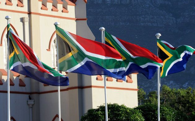 South African flags are seen during a ceremony ahead of South Africa's newly-minted president National address at the Parliament in Cape Town, on February 16, 2018. The State of the Nation address is an annual mix of political pageantry and policy announcements, but the flagship event was postponed last week as Zuma battled to stay in office. / AFP PHOTO / X00388 / Nasief Manie (Photo credit should read NASIEF MANIE/AFP/Getty Images)