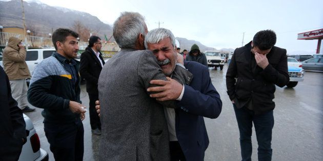 Relatives of passengers who were believed to have been killed in a plane crash react near the town of Semirom, Iran, February 18, 2017.