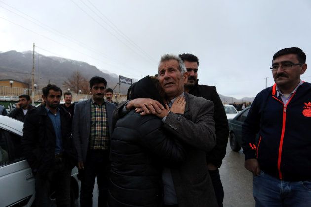 Relatives of a passenger who was believed to have been killed in a plane crash react near the town of Semirom, Iran, February 18, 2017.