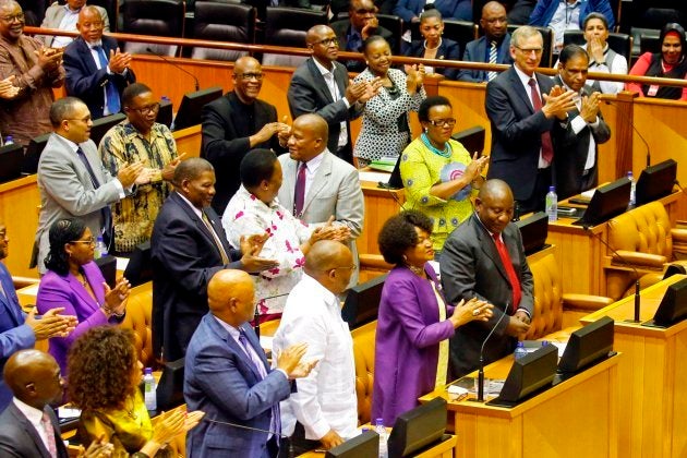 Members of Parliament and South African National Assembly speaker Baleka Mbete (front 2nd R) applaud former South African Deputy president Cyril Ramaphosa (front R) during a session at the Parliament in Cape Town prior to his swearing in as South Africa's President, on February 15, 2018.