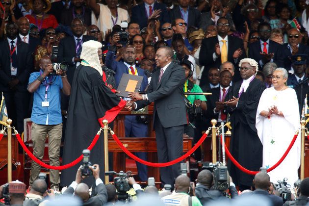 Kenya's President Uhuru Kenyatta shakes hands with Chief Justice David Maraga as he takes the oath of office during his swearing-in ceremony at Kasarani Stadium in Nairobi, Kenya November 28, 2017.