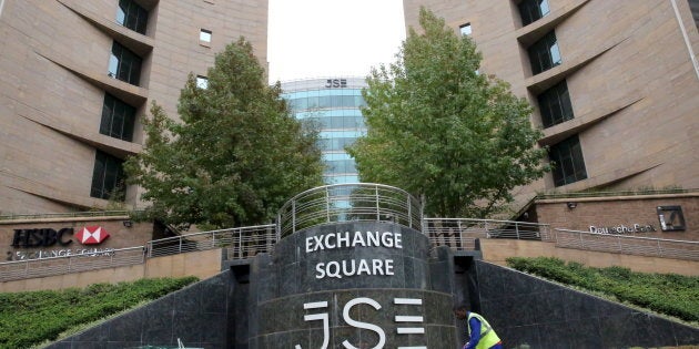 A worker sweeps in front of the Johannesburg Stock Exchange (JSE), in this picture taken March 23, 2016. Picture taken March 23, 2016. REUTERS/Philimon Bulawayo.