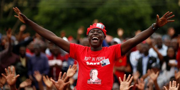 Mourners cheer as the coffin passes at the funeral parade held for the late Movement For Democratic Change (MDC) leader Morgan Tsvangirai in Harare, Zimbabwe February 19, 2018.