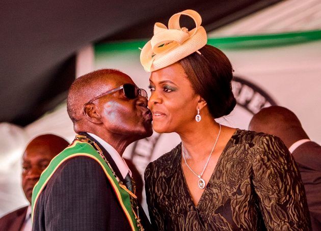 (FILES) This file photo taken on April 18, 2017 shows former president Robert Mugabe kissing his wife and then-first lady Grace Mugabe during during the country's 37th Independence Day celebrations at the National Sports Stadium in Harare. Zimbabwe's military appeared to be in control of the country on November 15, 2017 as generals denied staging a coup but used state television to vow to target "criminals" close to President Robert Mugabe. Mnangagwa's dismissal left Mugabe's wife Grace, 52, in prime position to succeed her husband as the next president -- a succession strongly opposed by senior ranks in the military. / AFP PHOTO / Jekesai NJIKIZANA