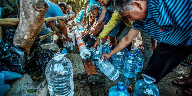 Cape Town residents queue to refill water bottles at Newlands Spring on January 31, 2018.