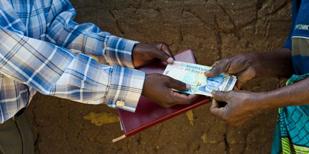 Money changes hands in Salima District, Malawi.