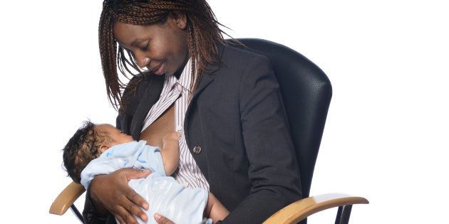 An African American businesswoman breastfeeding.