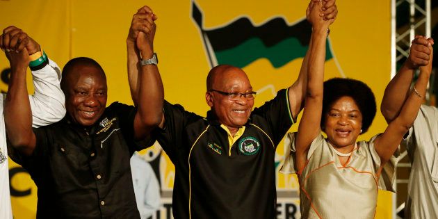 President Jacob Zuma (m) celebrates his re-election as ANC president in 2012 alongside newly-elected party deputy president Cyril Ramaphosa and re-elected chairperson Baleka Mbete.