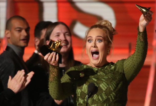 Adele breaks the Grammy for Record of the Year for "Hello" after having it presented to her at the 59th Annual Grammy Awards in Los Angeles, California, U.S.