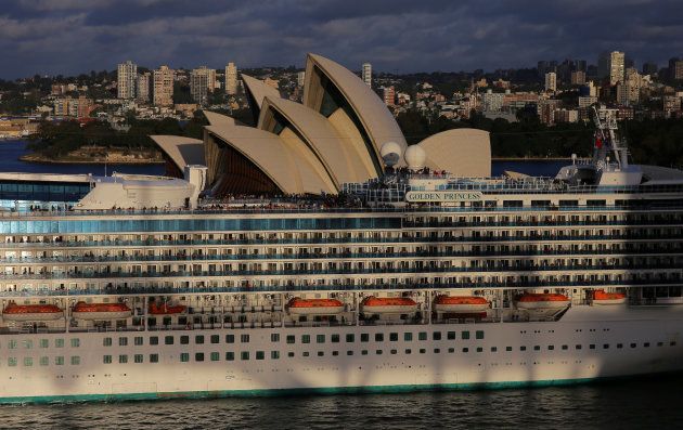 The setting sun casts the shadow of the Sydney Harbour Bridge onto the cruise ship Golden Princess as she passes in front of the Sydney Opera House in Sydney, Australia, August 2, 2017. Picture taken August 2, 2017. REUTERS/Steven Saphore