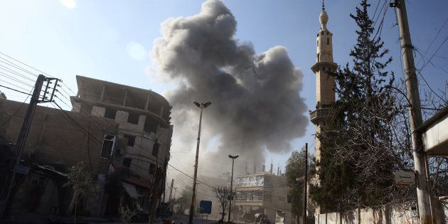 Smoke rises from the rebel held besieged town of Hamouriyeh, eastern Ghouta, near Damascus, Syria, February 21, 2018.