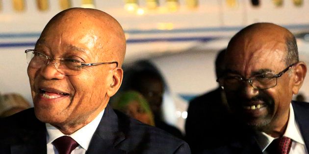 Sudanese President Omar al-Bashir (r) welcomes South African President Jacob Zuma at Khartoum airport on January 31 2015.