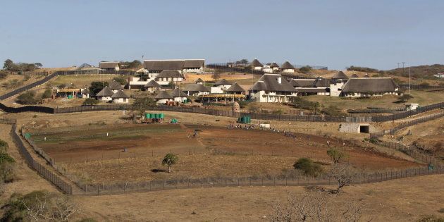 A general view of the Nkandla home (behind the huts) of South Africa's President Jacob Zuma in Nkandla is seen in this file picture taken August 2, 2012. REUTERS/Rogan Ward/Files