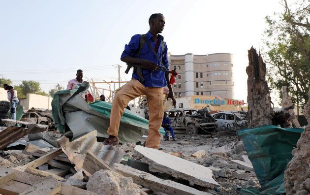A security officer from Doorbin Hotel assesses the debris after a suicide car explosion in front of the hotel in Mogadishu, Somalia February 24, 2018.