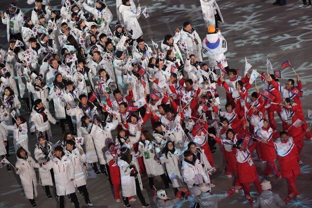 North Korean and South Korean delegations wave their flags along with the Unified Korea flag during the closing ceremony of the Pyeongchang 2018 Winter Olympic Games at the Pyeongchang Stadium on February 25, 2018.