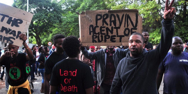 JOHANNESBURG, SOUTH AFRICA â APRIL 07: A small group of pro-Zuma members from Black Land First (BLF) confront anti-Zuma protestors gathered outside the Gupta's Saxonwold residence calling for President Zuma to step down on 07 April 2017 in Johannesburg, South Africa. Protesters gathered outside the Guptaâs compound whom, through their businesses, are accused of links to government officials and the president. (Photo by Gallo Images / Dino Lloyd)