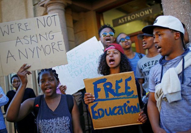 University of Cape Town (UCT) students hold placards during protests demanding free tertiary education in Cape Town. October 3, 2016. REUTERS/Mike Hutchings