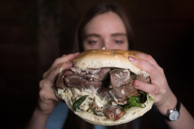 Fiona Gray tucks into a giant burger at a restaurant pop-up in London.