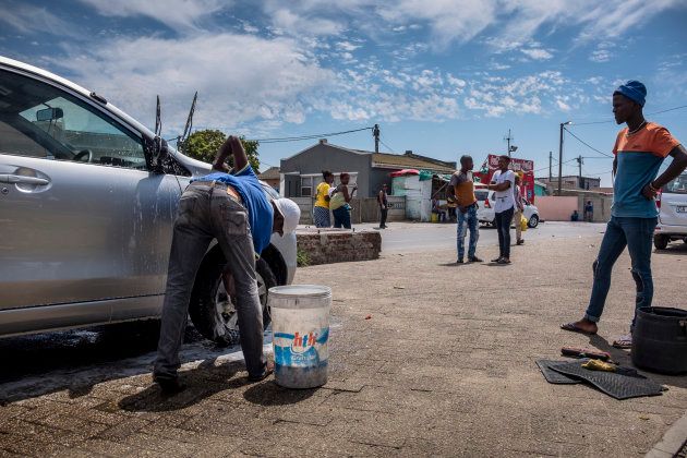 CAPE TOWN, SOUTH AFRICA - FEBRUARY 14: Akena Dubanga, who owns this car wash in Gugulethu township, says they are no longer using hoses to wash the cars and now they're using buckets in order to use less water per car, on February 14, 2018. Citizens of Cape Town reduce their water usage in face of Day Zero, the day the city will turn off it's taps as a result of a three year drought plaguing the Western Cape, on February 14, 2018. (Photo by Charlie Shoemaker for The Washington Post via Getty Images)