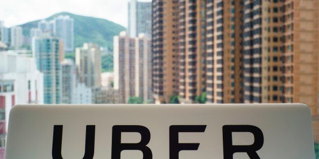 A sign with an Uber logo is seen in the smartphone ride-hailing giant's office in Hong Kong on July 13, 2017. / AFP PHOTO / Aaron TAM (Photo credit should read AARON TAM/AFP/Getty Images)
