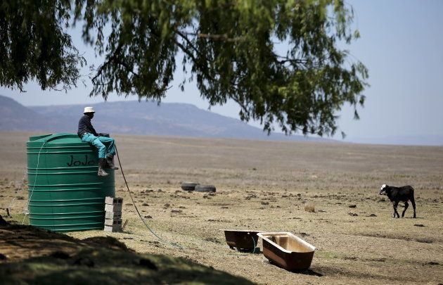 A farm worker sits on a water tank as he supplies his livestock with water at a farm outside Utrecht, a small town in the northwest of KwaZulu-Natal, November 8, 2015. REUTERS/Siphiwe Sibeko