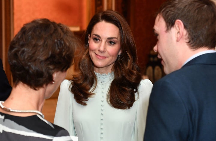 Catherine, Duchess of Cambridge, talks with guests as she attends a reception to mark the 50th Anniversary of the investiture